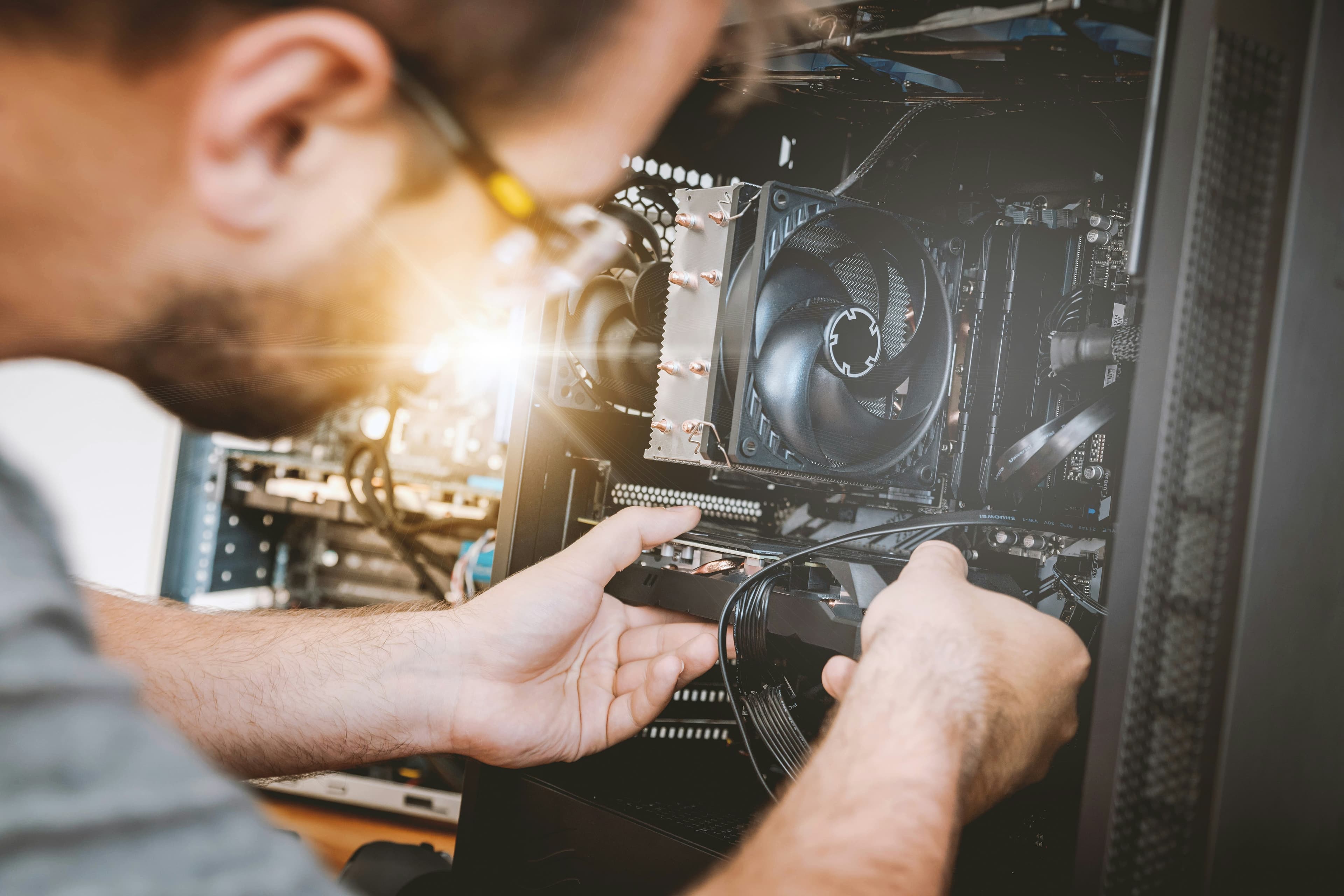 Person building a custom PC with components