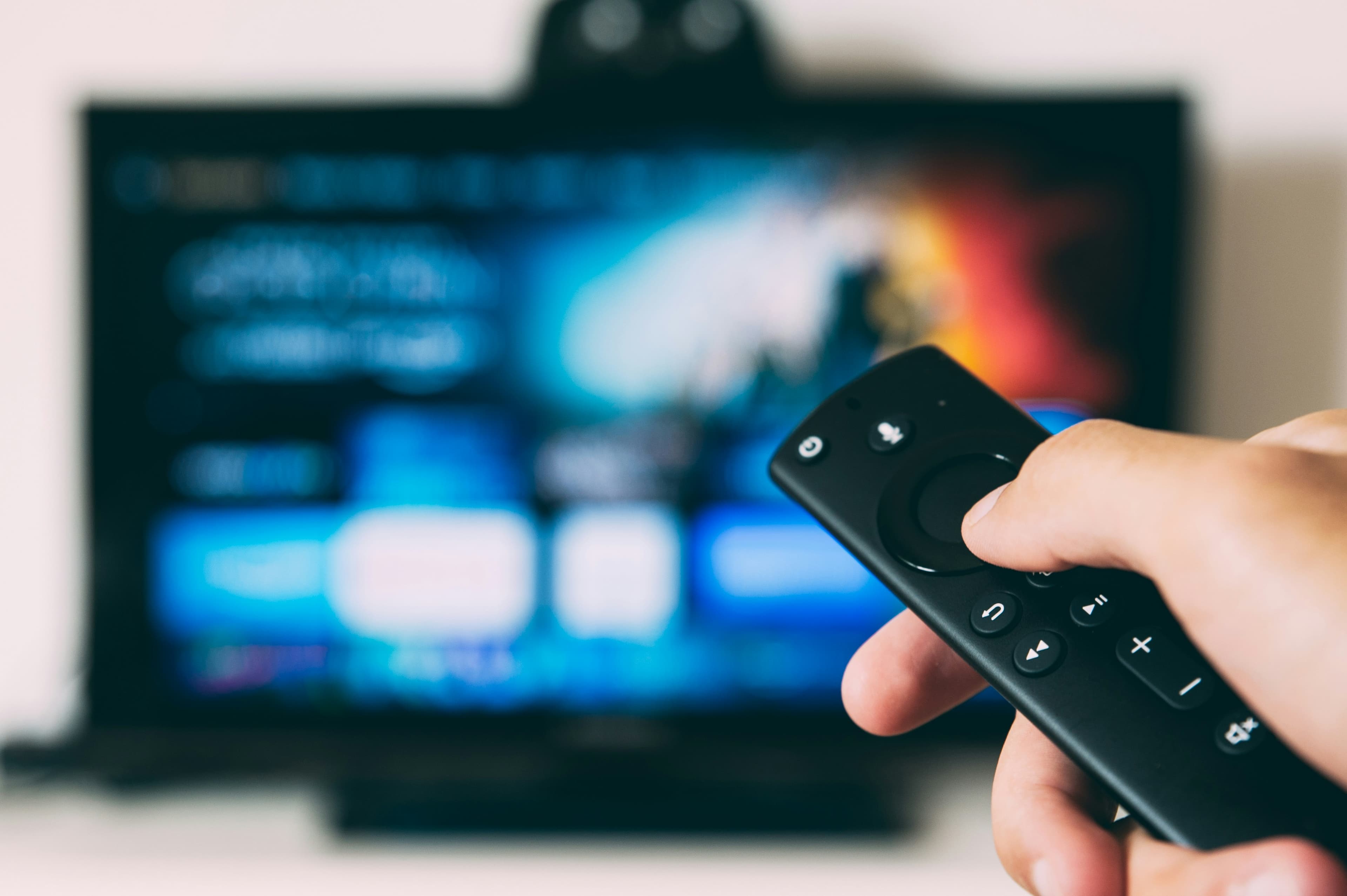 Modern smart TV being turned on with remote control